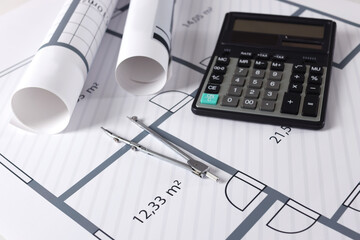 Construction drawings, calculator and dividers, closeup view