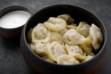 Boiled dumplings with meat in a pot