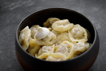 Boiled dumplings with meat in a pot
