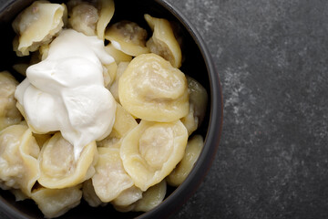 Boiled dumplings with meat in a pot