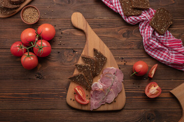 Ham meat and vegetables on wooden board