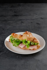 Сroissant with ham and salad