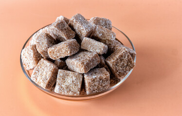 A close up view of a bunch of brown sugar cubes