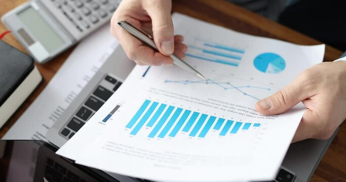 Business man analyzes financial indicators, key figures and kpi