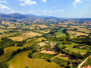 Fototapeta na wymiar Spring view from a drone to green fields Tuscany Italy