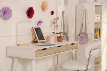 Stylish teenager's room interior with computer and floral decor