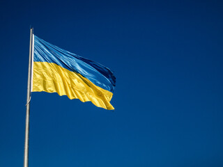 Ukrainian yellow blue flag flutters waving in the wind. National symbol of Ukraine in sky. Freedom concept.