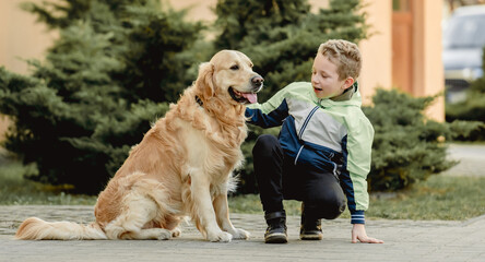 Preteen boy with golden retriever dog