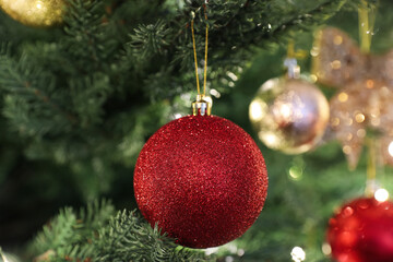 Beautifully decorated Christmas tree with red bauble, closeup