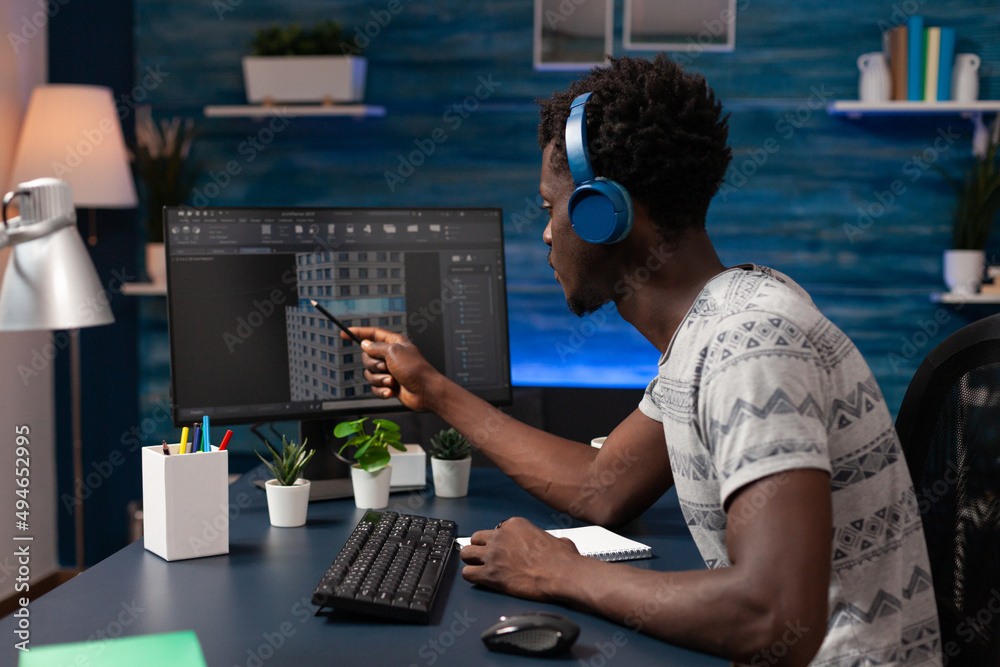 Poster real estate technical architect with headphones pointing at building construction on computer workin