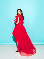 High fashion portrait of young beautiful brunette woman wearing nice trendy red evening fluffy...