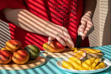 chef cutting fruits. Female hands cutting mango and passion fruit, fruit breakfast