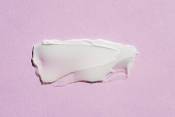 A smear of cream or face mask. The appearance of the texture of the cream on pink background. Skincare products , natural cosmetic. Beauty concept for face and body care