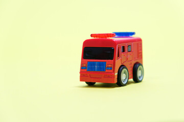 Red fire truck - plastic toy for children, special service toy car, banner for toy store.