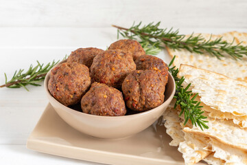 Beef meatballs and matzah bread for Jewish holiday Pesach or Passover.
 