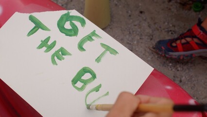 Draw letters on a sheet of paper. Expression of thought in creativity. Leisure activities in free time.