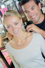 couple and holding a necklace