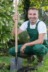handsome man digging with a shovel