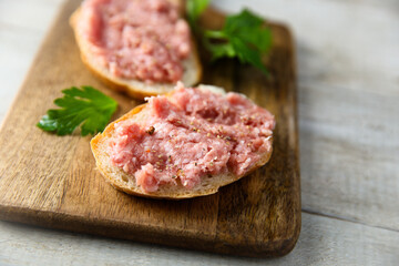 Fototapeta premium Traditional pork pate or sausage on a white bread