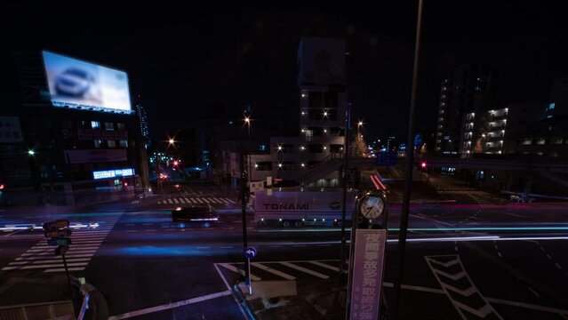 A night timelapse of the traffic jam at the city street in Tokyo wide shot panning