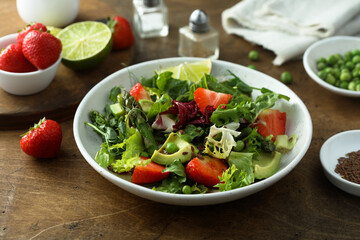 Healthy leaf salad with strawberry and avocado