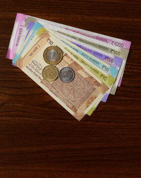 Assorted Indian rupee currency notes. Close up of all denominations of newly printed currency notes with coins.