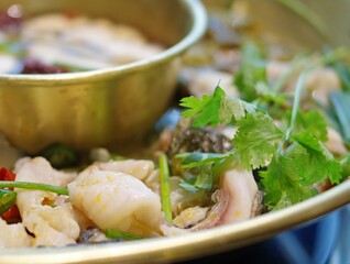 copper hot pot with fish and coriander