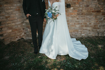 Happy couple in love. Gorgeous bride and stylish groom. Romantic moments of newlyweds. Wedding photo.