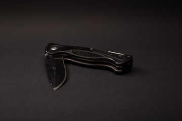 Black hunting knife on the background