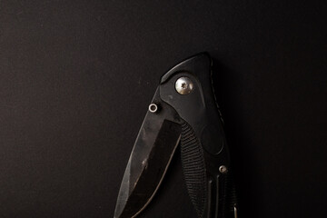 Black hunting knife on the background
