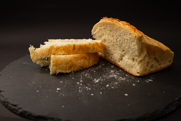 Baked white bread on a black background
