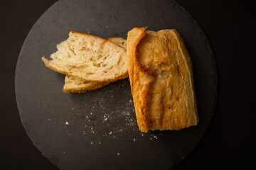 Baked white bread on a black background