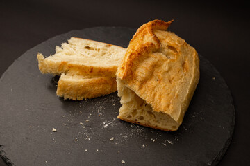 Baked white bread on a black background