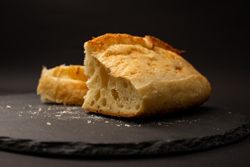 Baked white bread on a black background