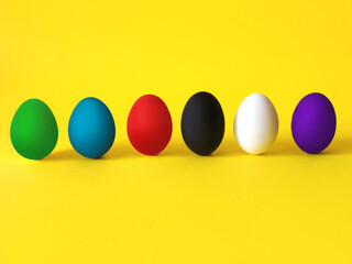 Colorful eggs on the yellow background. Black lives matter, all lives matter, diversity,  equal rights concept