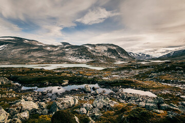 landscape with snow and clouds in the sky in the mountains of norway