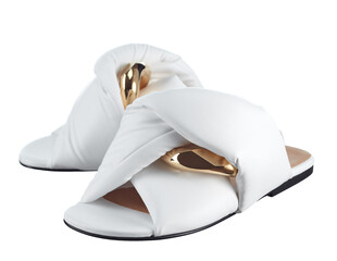 Infinitely beautiful women's sandals made of snow-white genuine leather, decorated with large links of a gold chain, isolated on a white background. Fashionable shoes.