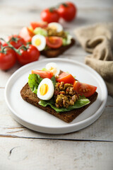 Fototapeta na wymiar Egg toast with tomato and olive paste