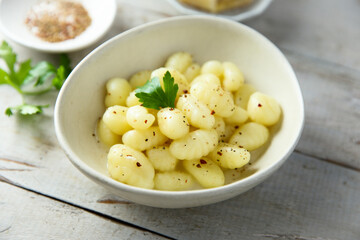 Homemade potato dumplings with black pepper and cheese