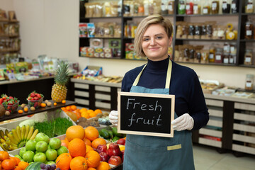Portrait of a young saleswoman with a sign in her hands 