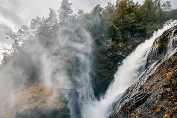 panorama view of waterfall in norway on a rainy summer day