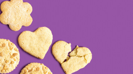 Butter and peanut cookies on purple background with copy space.
