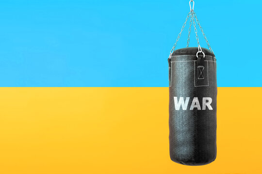 punching bag hanging on colorful flag of Ukraine