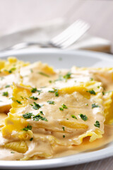 Fresh Handmade Ravioli with Cream on a Plate.