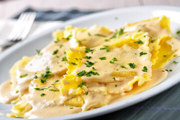 Fresh Handmade Ravioli with Cream on a Plate.