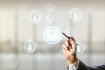 Double exposure of man hand with pen working with abstract virtual social network icons on blurred office background. Marketing and promotion concept