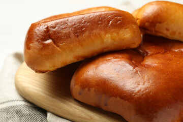 Delicious baked patties on kitchen towel, closeup