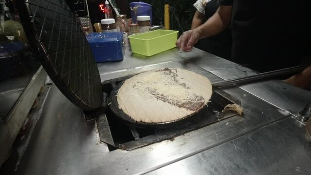 Marquesita Mexican street snack being prepared with hazelnut chocolate and Edam cheese