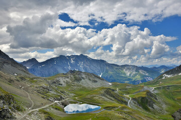 Majestic mountain landscape with lake from Les Arcs 2000 ski station in Red Peaks massif in summer. Savoie, France.