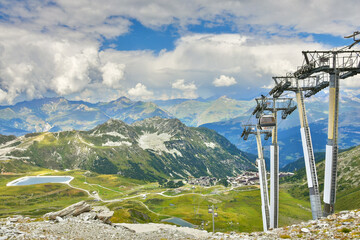 Alpine view and cable car near Arcs 2000 ski station in Savoie, France. Mountain summer resort...